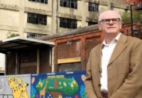 Image shows Councillor Neil MacDonald outside the former Burtons building