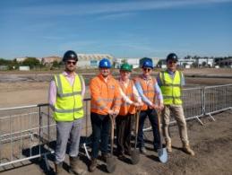 Image shows five men on site marking the start of works