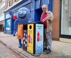 Image shows DiGBY and Cllr Smart with one of the new recycling bins in Ipswich Town Centre