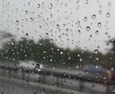 Rain on a window looking out of a car