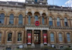 Image shows Ipswich Town Hall with large poppy