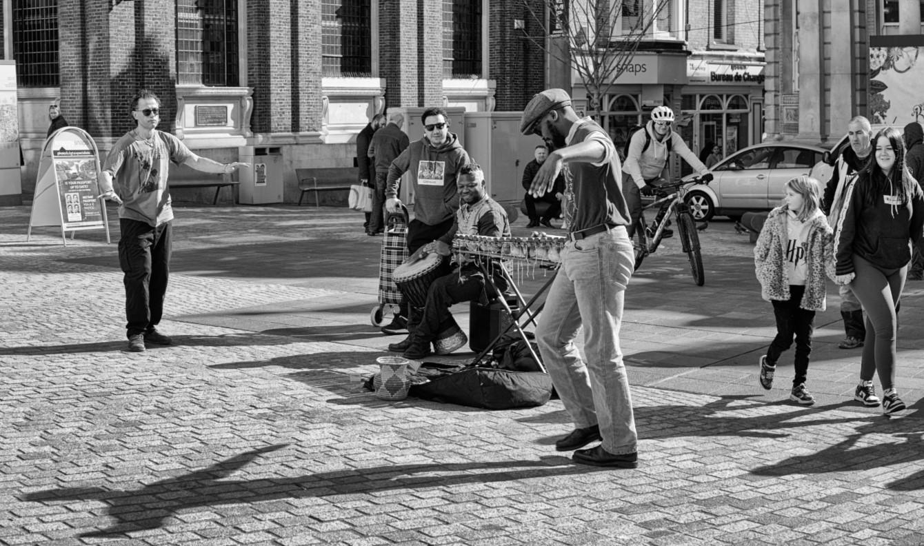 Photo of street performers playing music.
