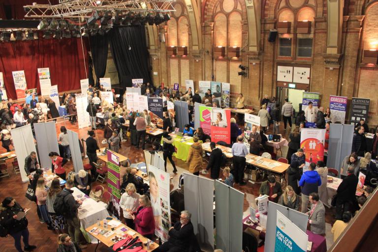 Photo of the Ipswich Jobs & Careers Fair showing an event with various booths and tables set up by different employers.