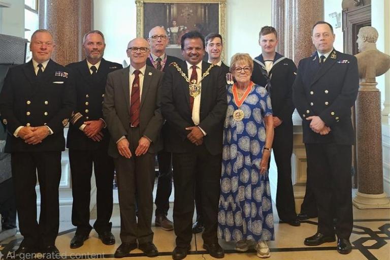 A group showing three local councillors with the crew of HMS Trumpeter at Ipswich Town Hall