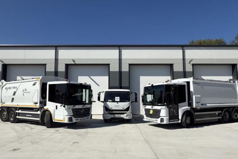 A photo of the three electric refuse collection vehicles outside Layard House