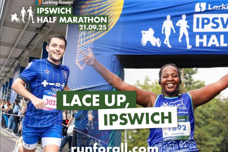 Male and female runners at finish line of Ipswich Half Marathon event