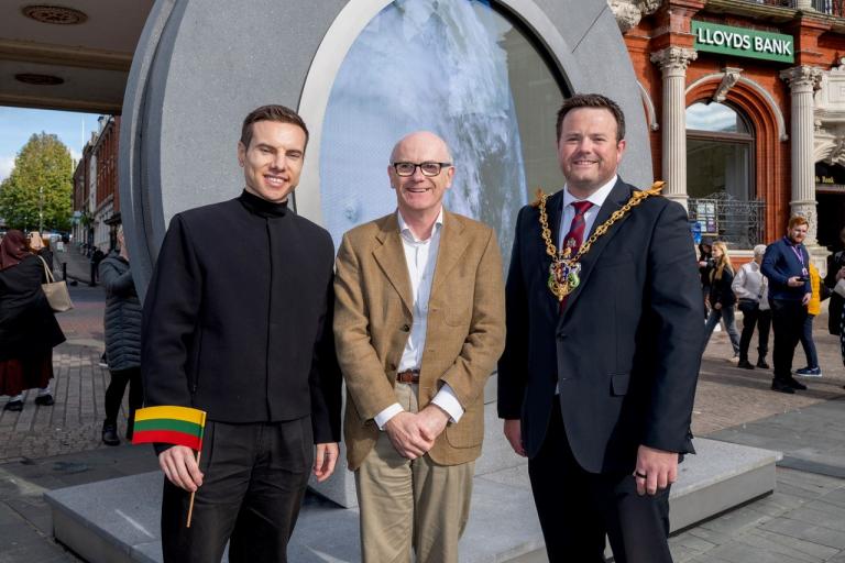 Cllr MacDonald posing in front of portal