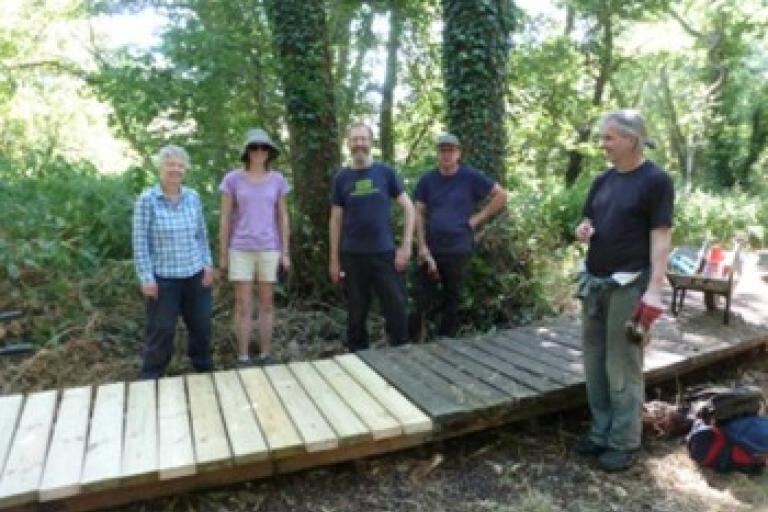 Group of Volunteers repairing a boardwalk at Belstead Brook