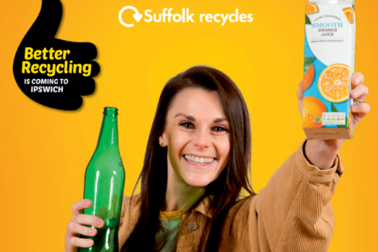 A woman holding up items that can be recycled