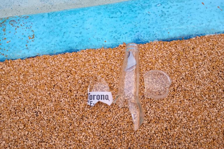 A broken beer bottle on the ground