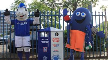 Mascots Bluey and DiGBY standing next to one of the new Ipswich Borough Council bins