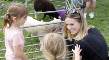 A family at one of Ipswich Borough Council's Family Fun Days in 2023 with some farm animals