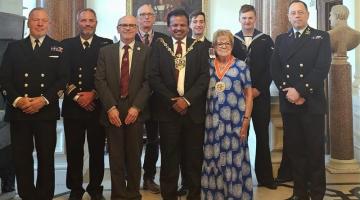 A group showing three local councillors with the crew of HMS Trumpeter at Ipswich Town Hall