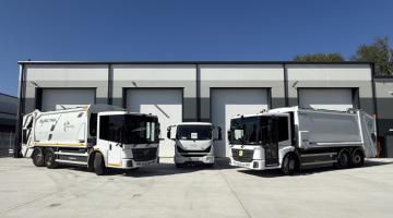 A photo of the three electric refuse collection vehicles outside Layard House
