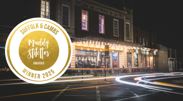 Logo and exterior of Ipswich Regent Theatre at night