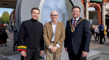 Cllr MacDonald posing in front of portal