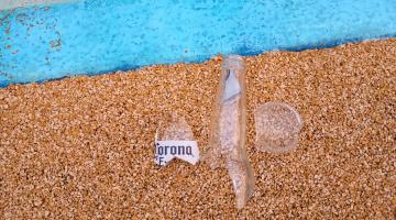 A broken beer bottle on the ground